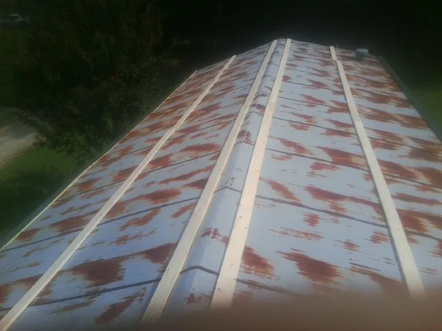 Rusted metal roof panels with new wood purlins before replacement — Storm Damage Roof Repair in Herkimer by Roofing Brothers